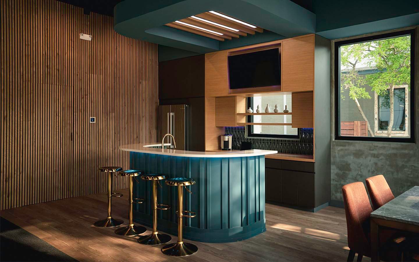 Home bar with brass stools and wood paneling