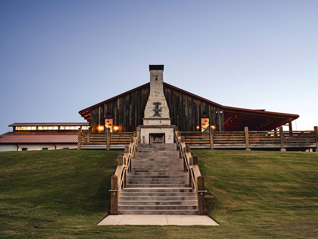 Stone chimney and staircase at a whiskey ranch at dusk