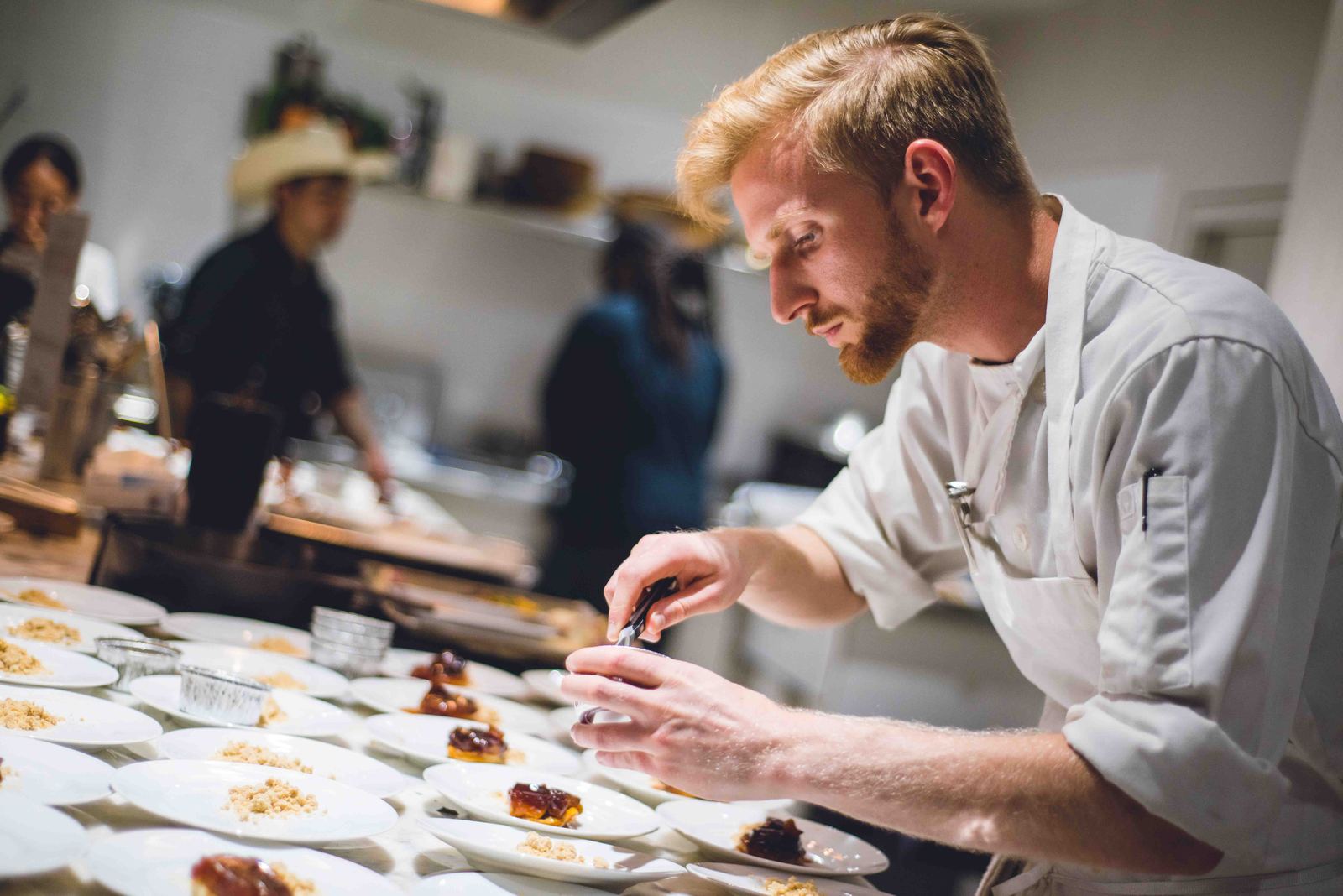 Chef plating appetizers at a catered event