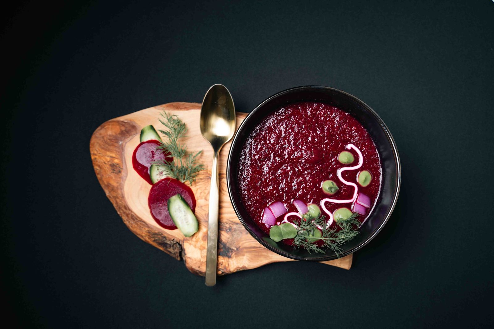 Beet soup served with a wooden board