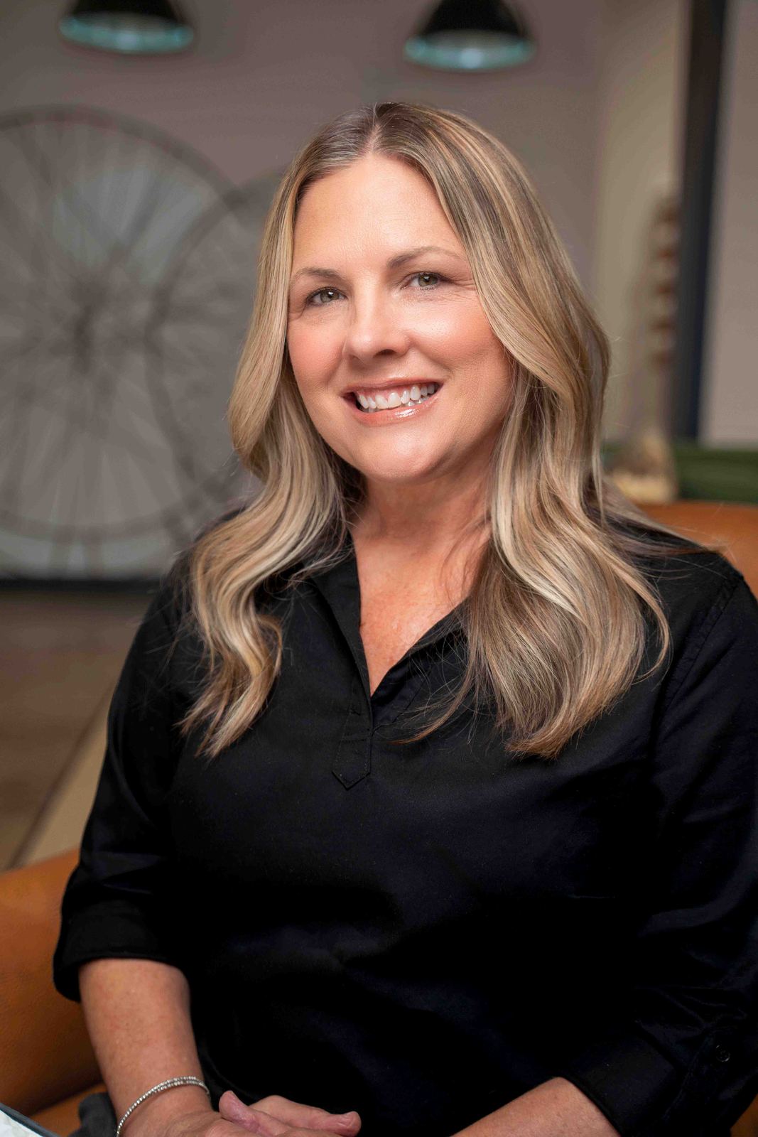 Headshot of a woman in a black blouse