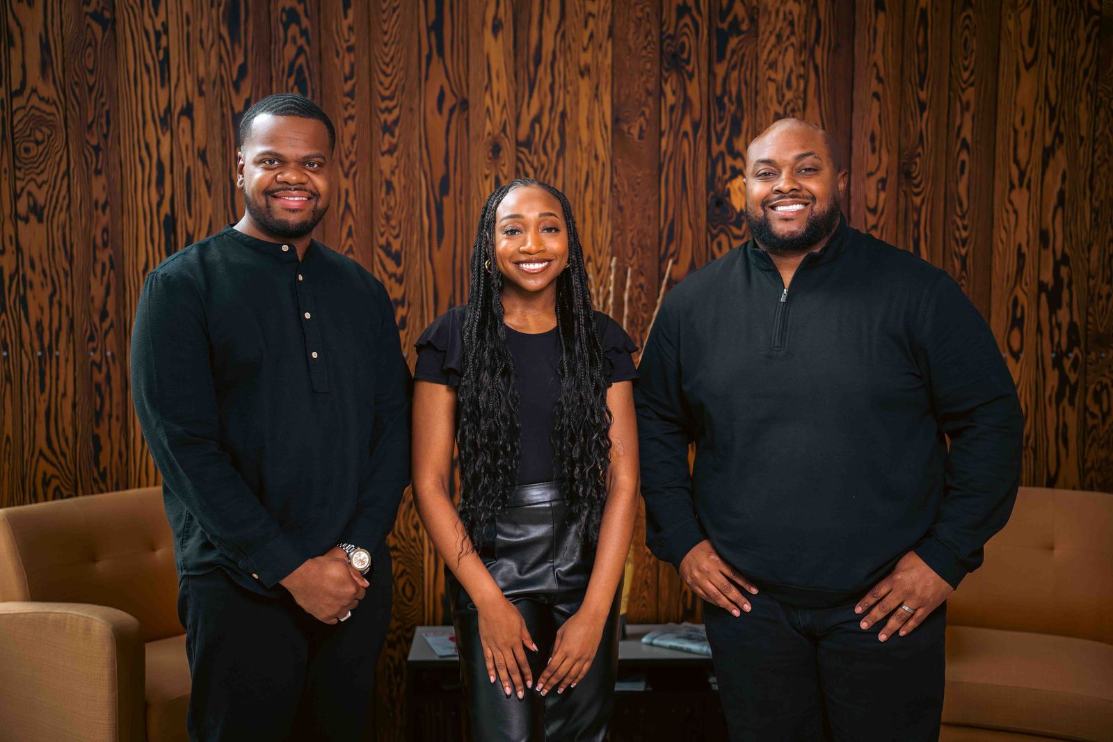 Three coworkers standing together for a team portrait