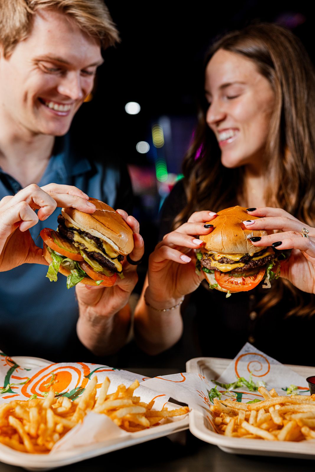 Couple sharing burgers at a restaurant