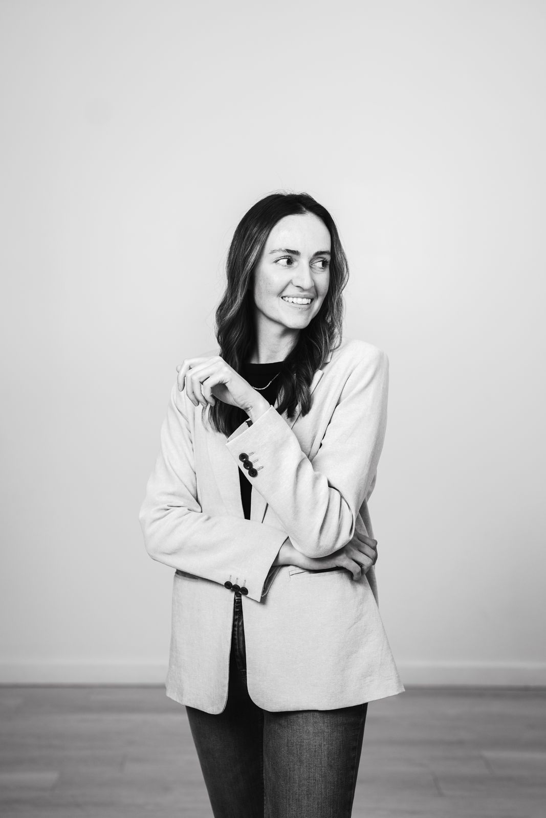 Black and white personal branding portrait of a woman in a blazer