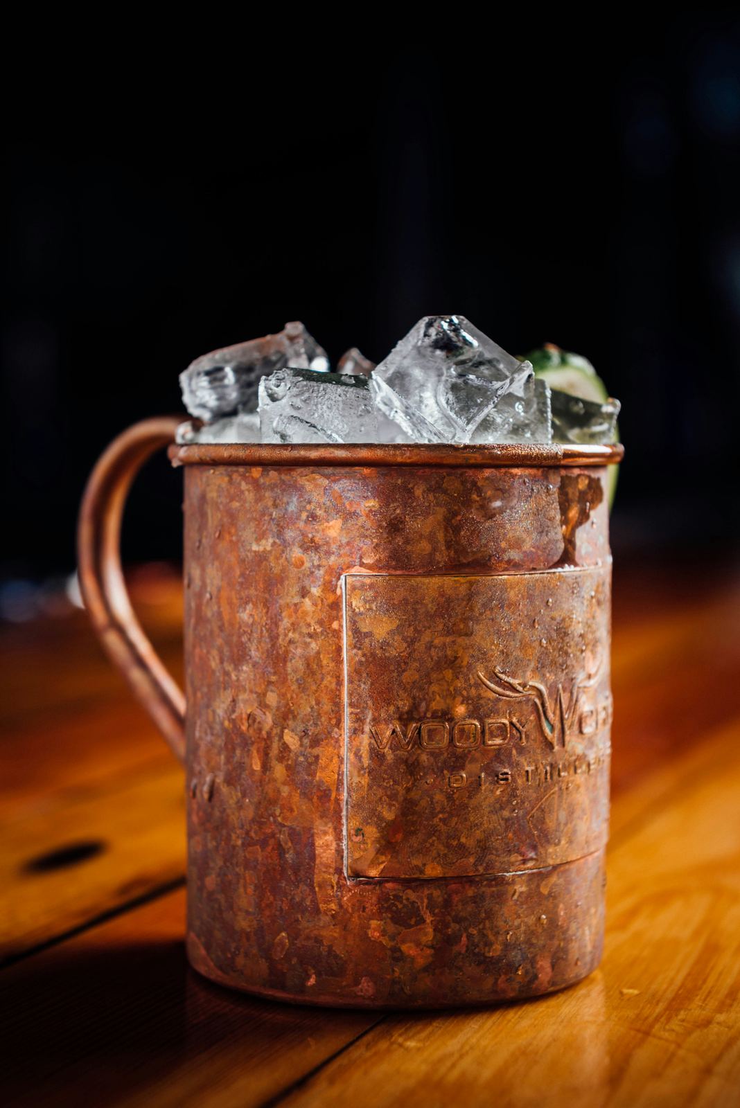 Copper mug with ice on a wooden bar