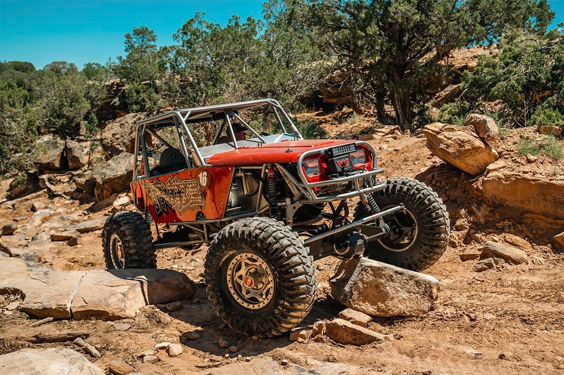 Custom off-road buggy climbing a rocky trail