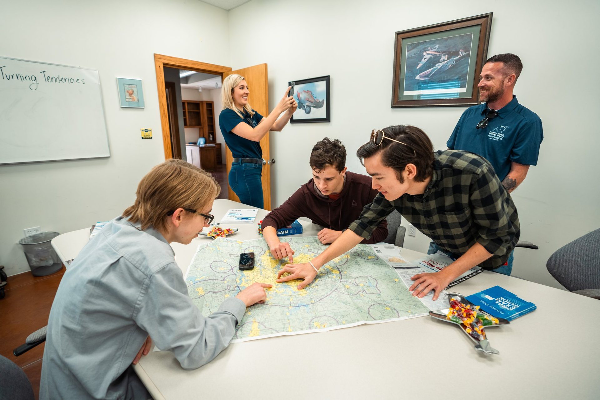 Students planning a route on a chart in ground school