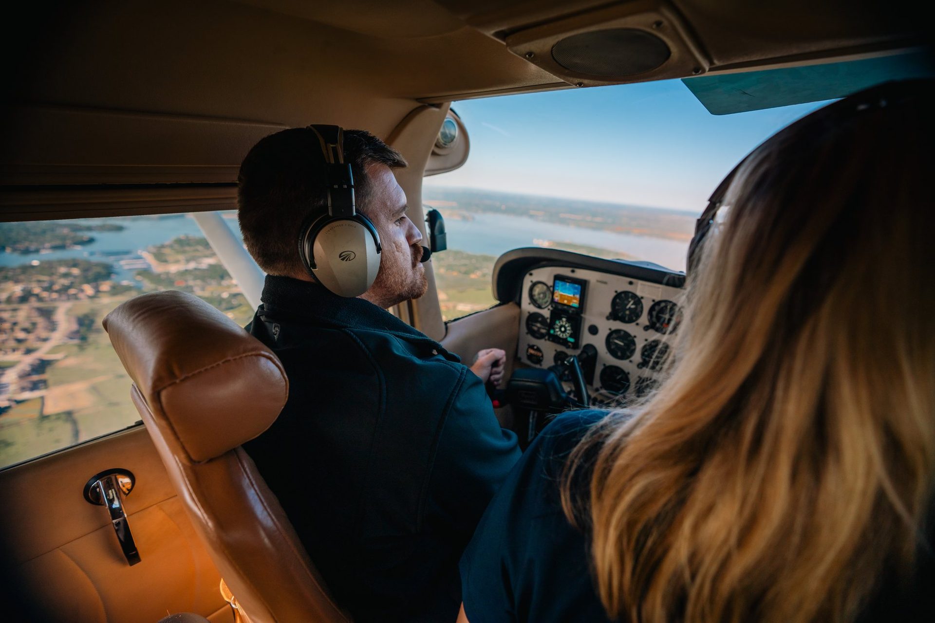 Instructor and student flying over the lake