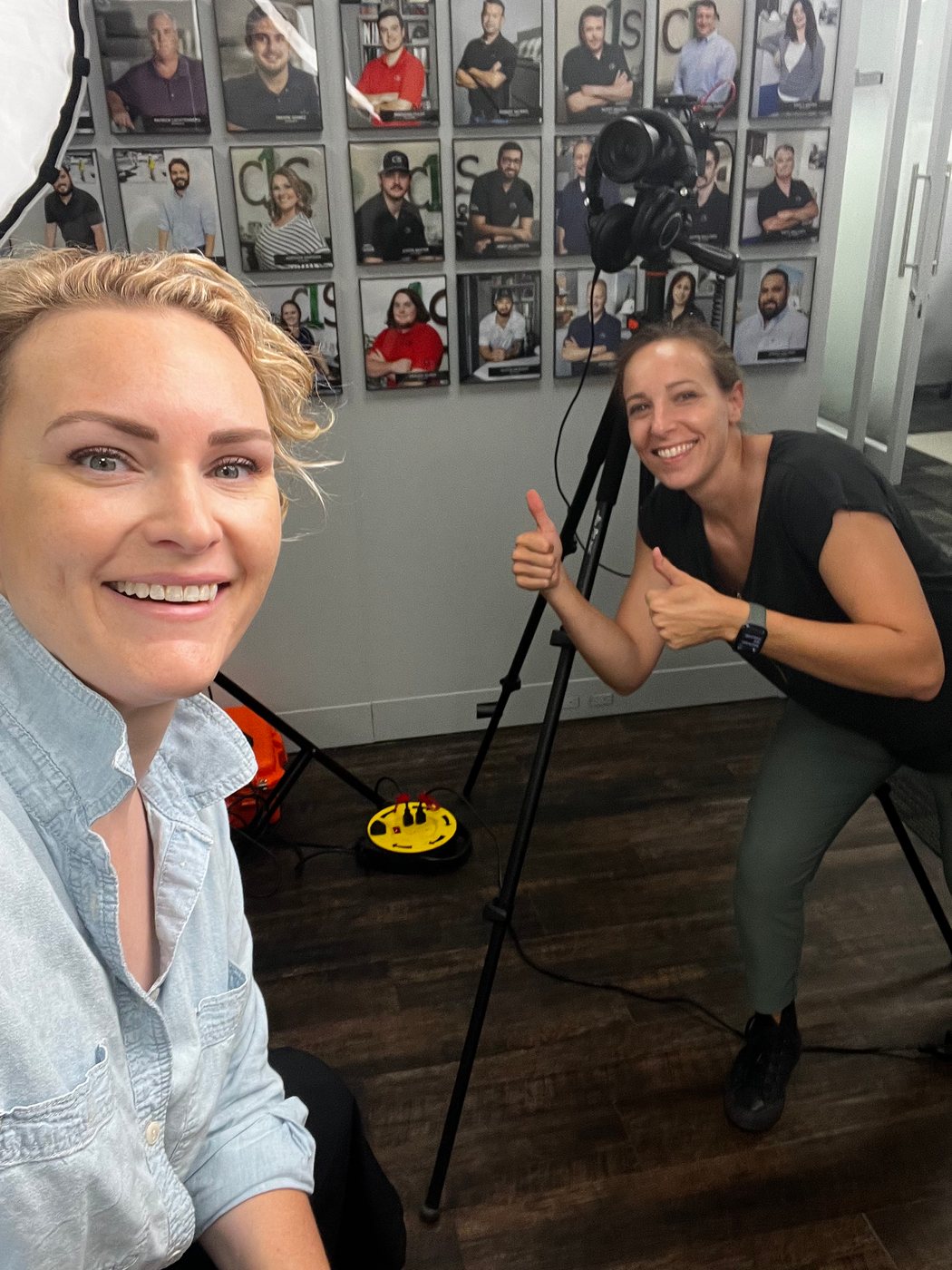 Susie Burleson giving a thumbs up behind the camera with a C1S team member