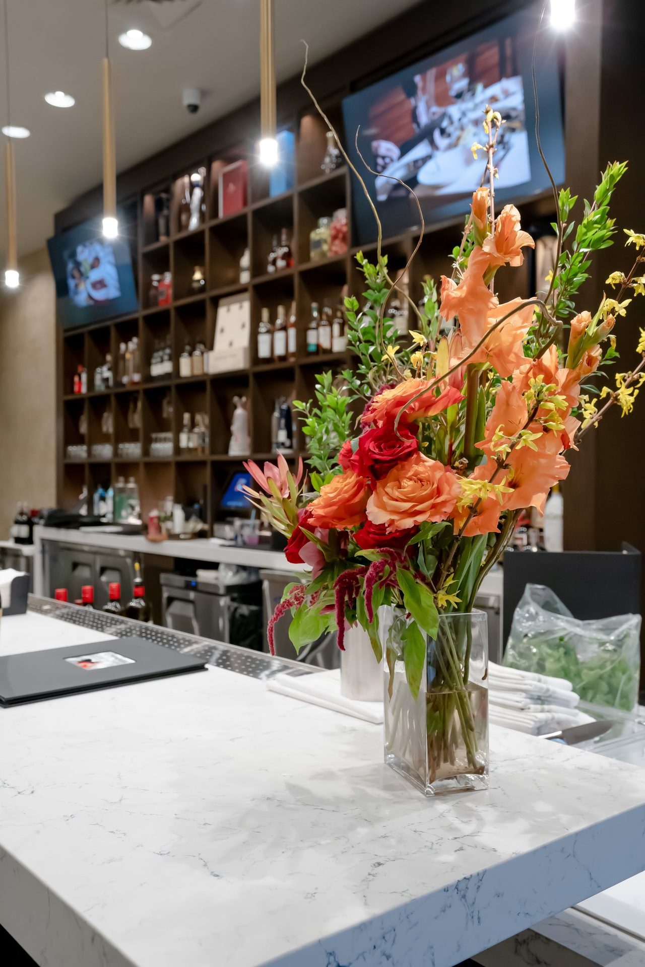 Marble bar with flowers and the wine wall
