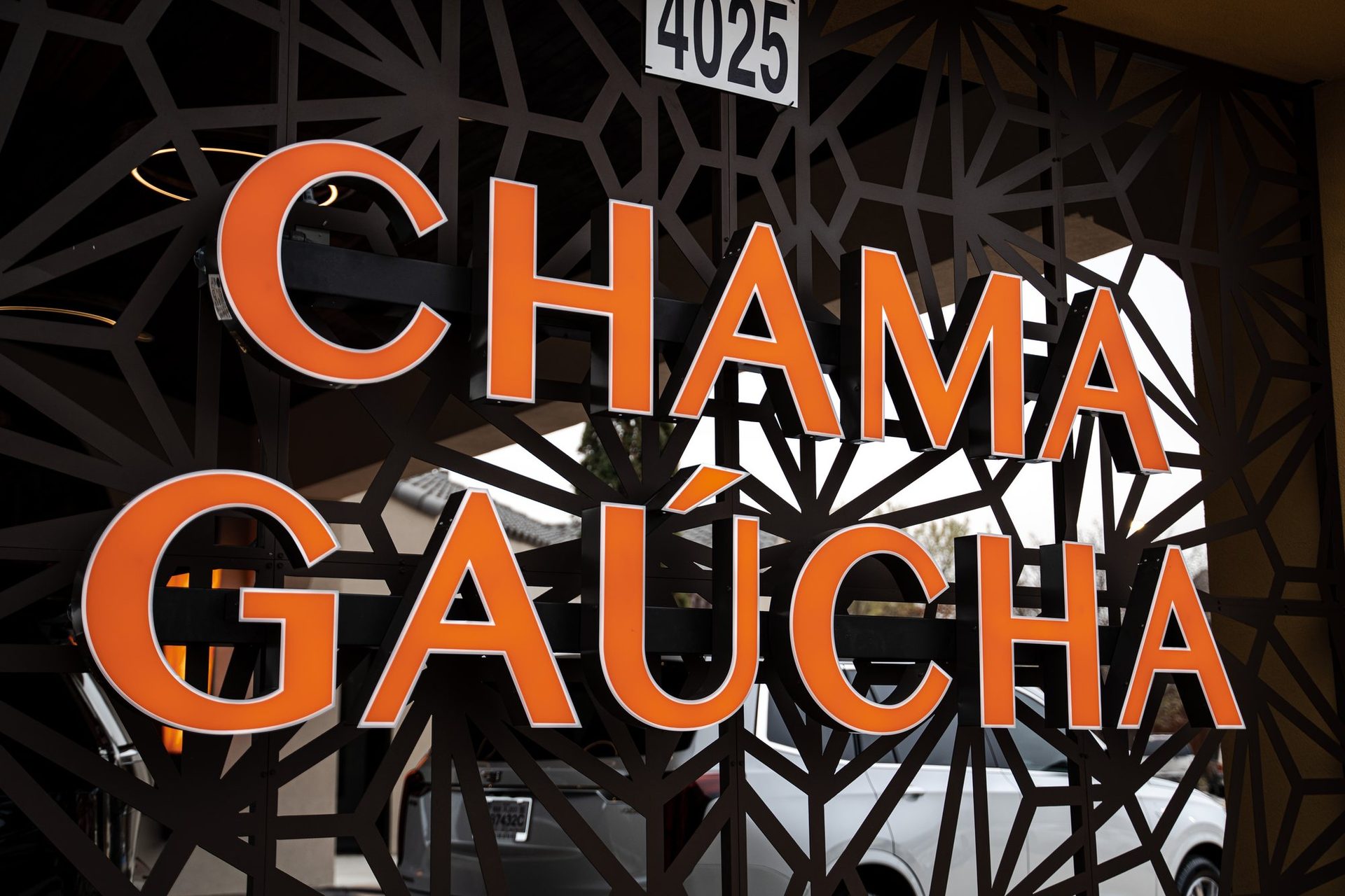 Chama Gaúcha sign glowing orange