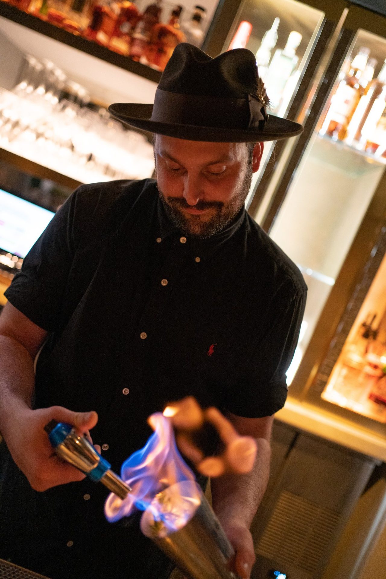 Bartender torching a cocktail shaker
