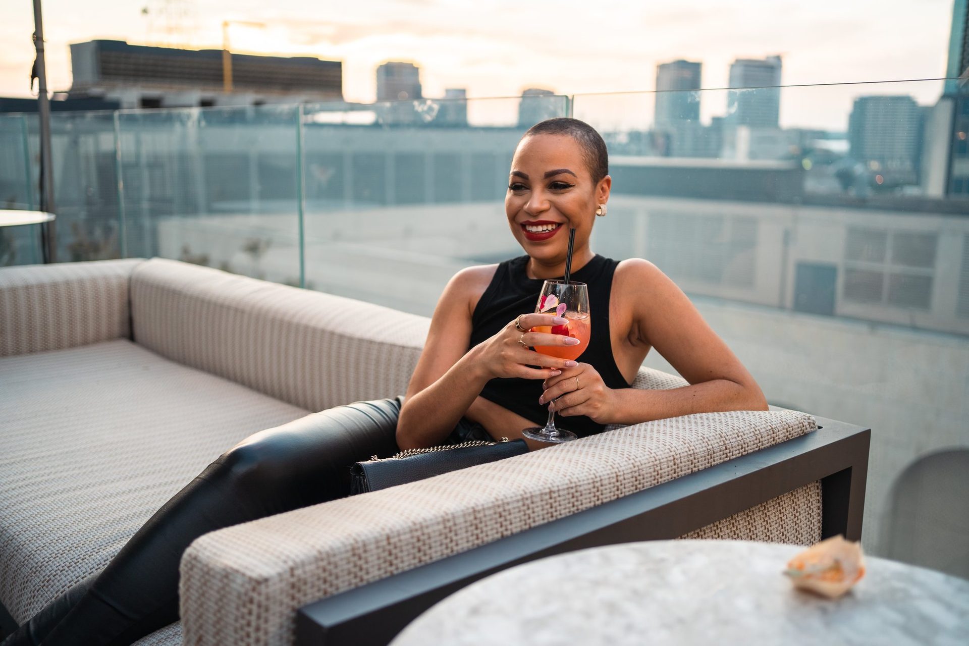 Guest relaxing on a rooftop sofa at sunset