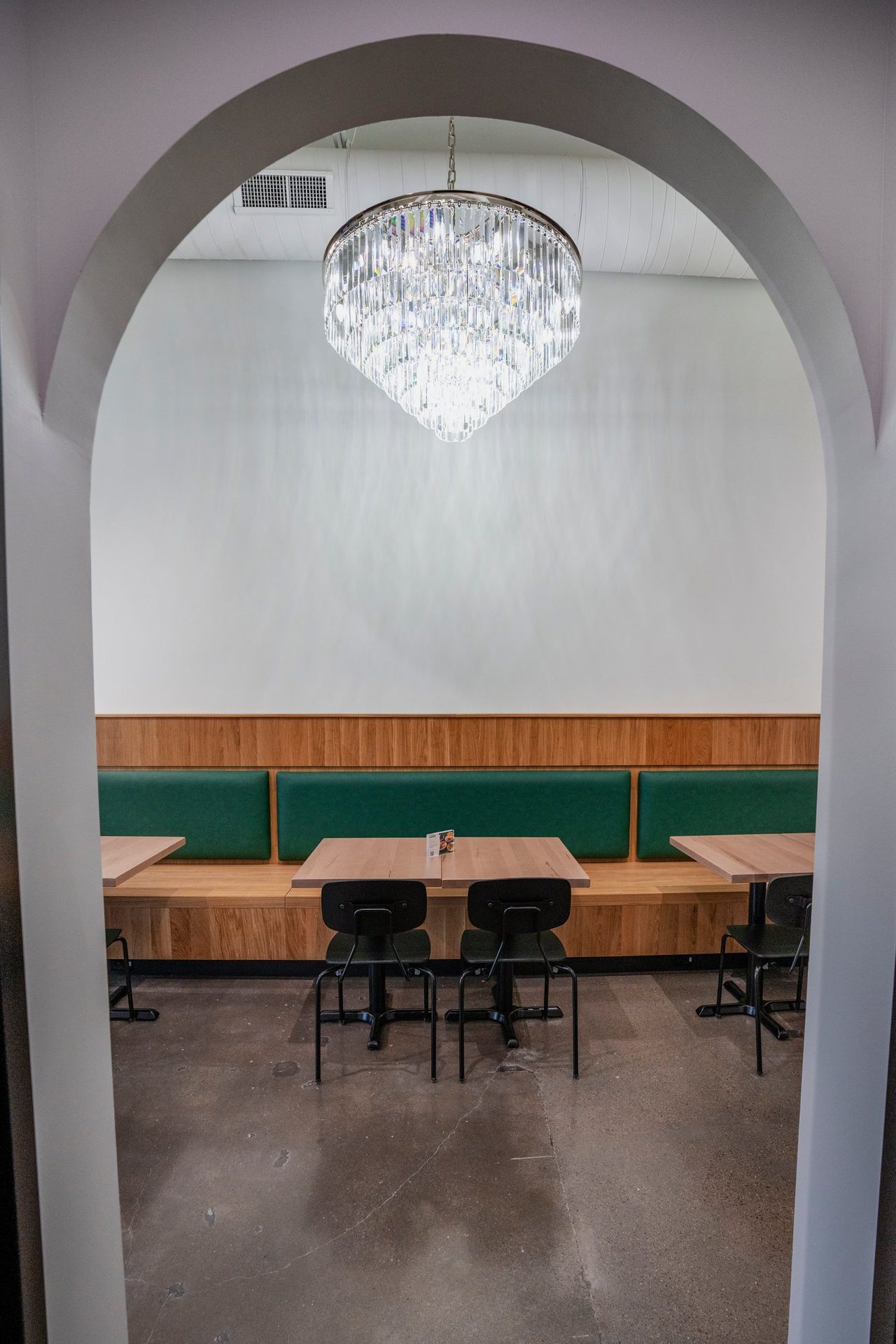 Arched dining nook with a chandelier