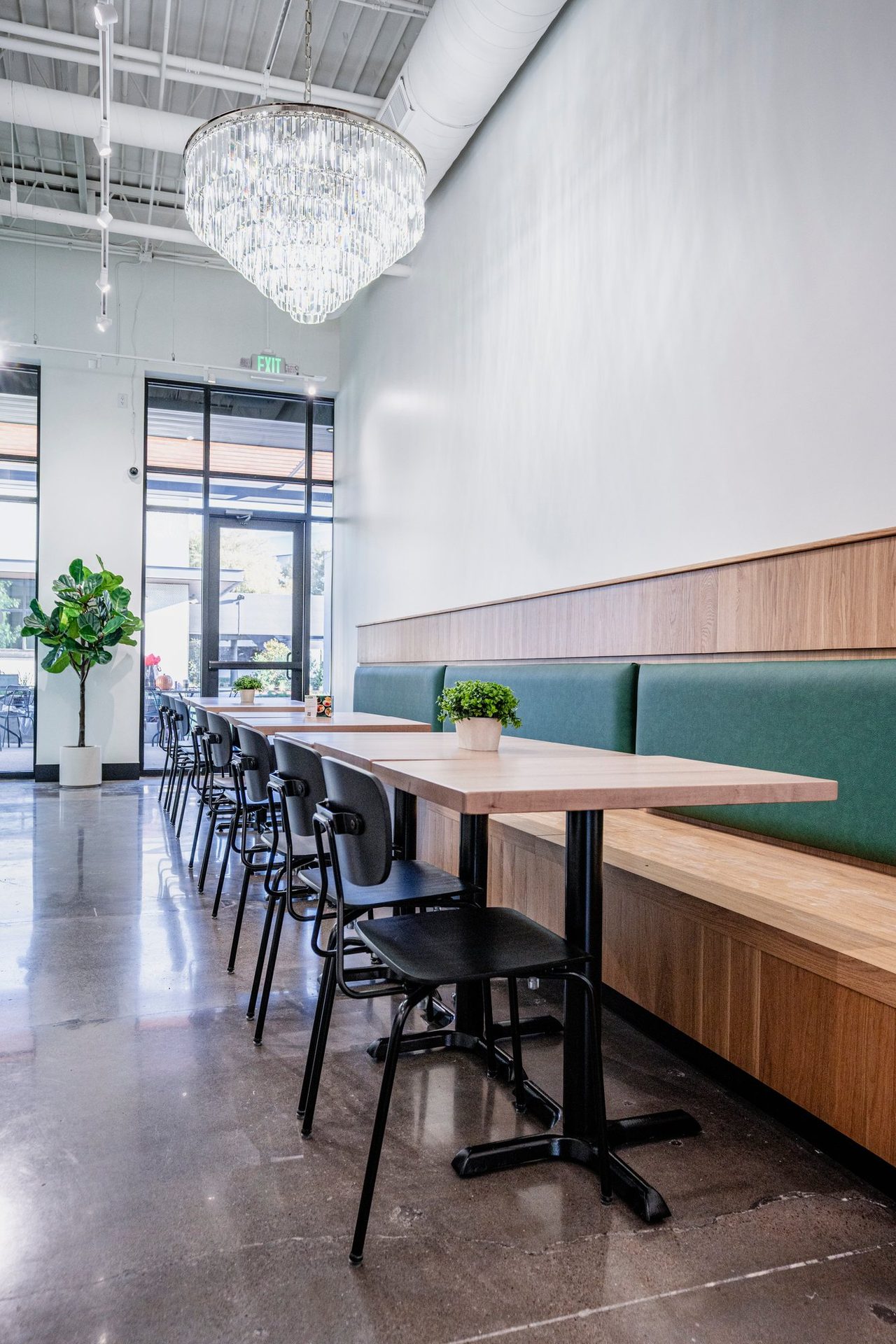 Dining room banquette under a crystal chandelier