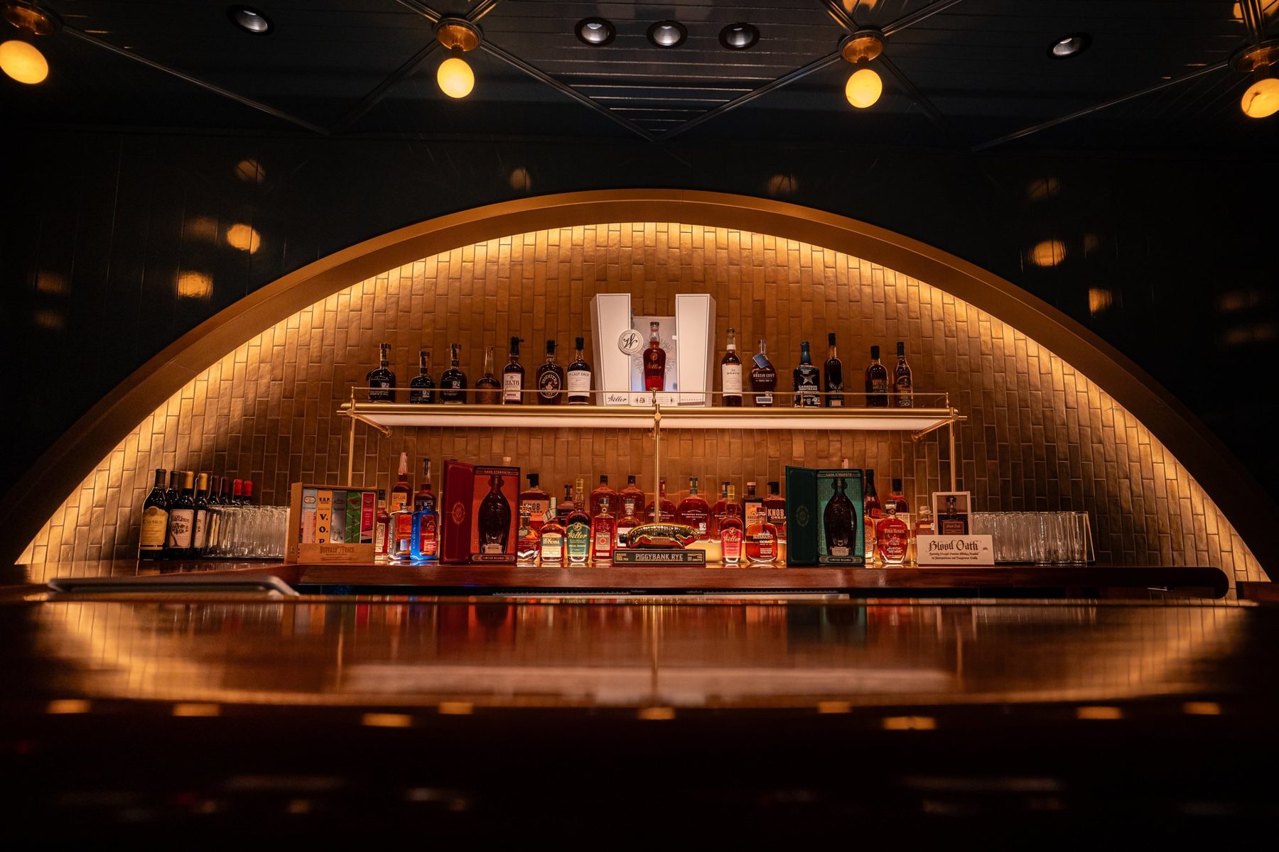 Arched back bar glowing in a dark room