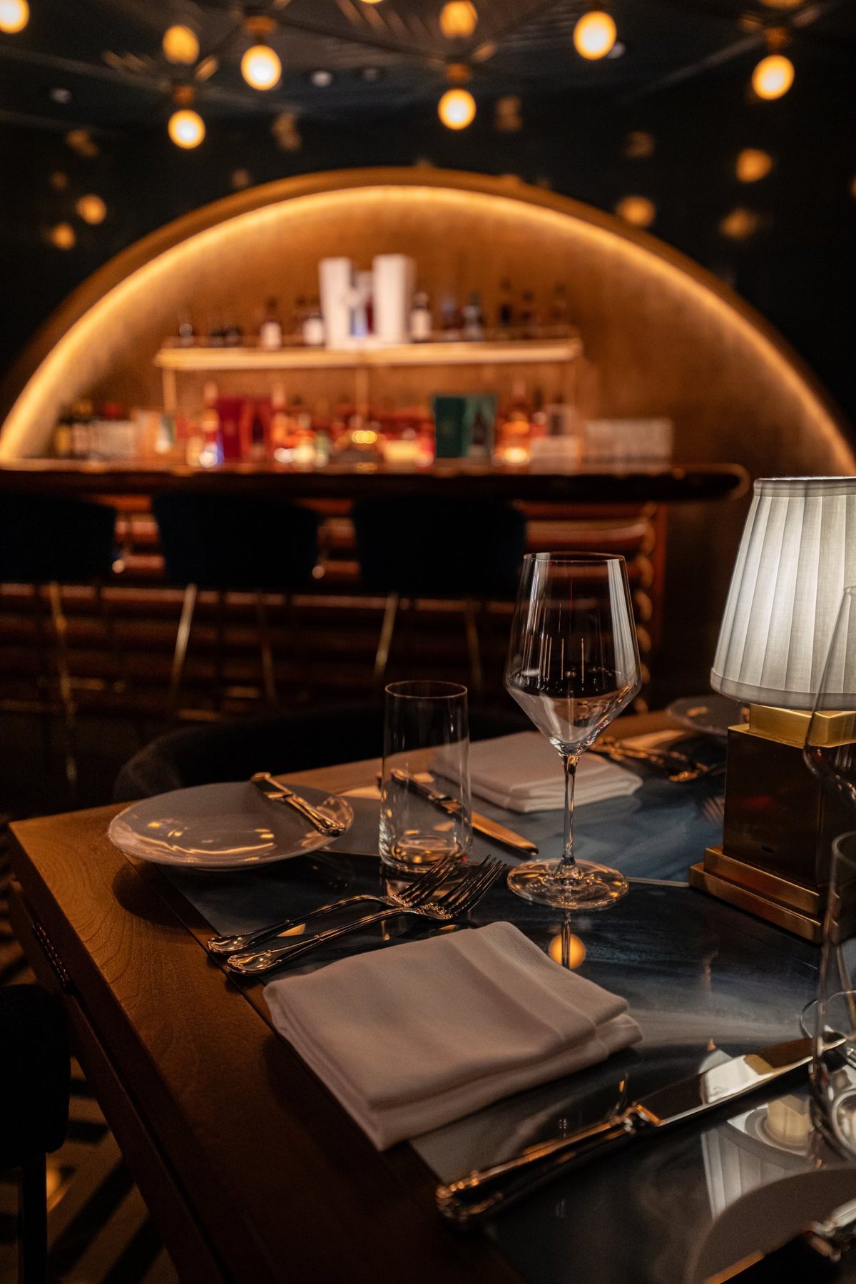 Table setting in front of the arched back bar