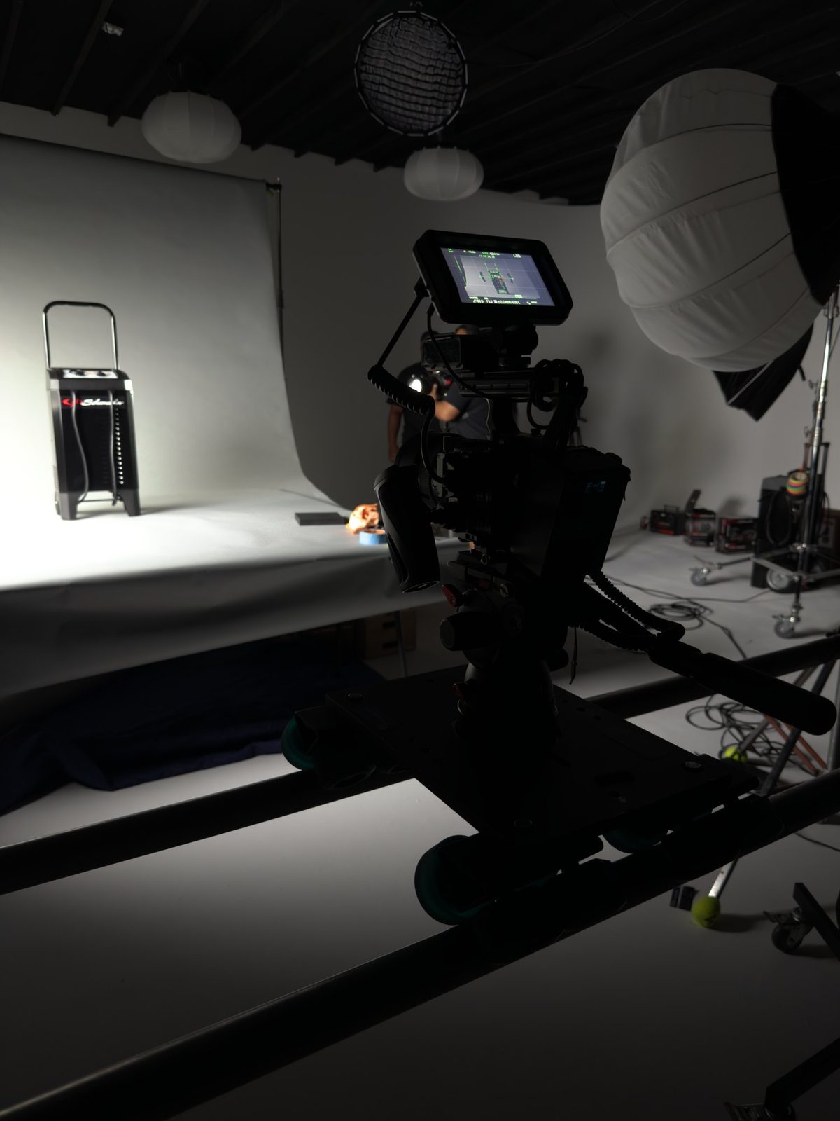 Cinema camera on a slider aimed at a Schumacher charger on set