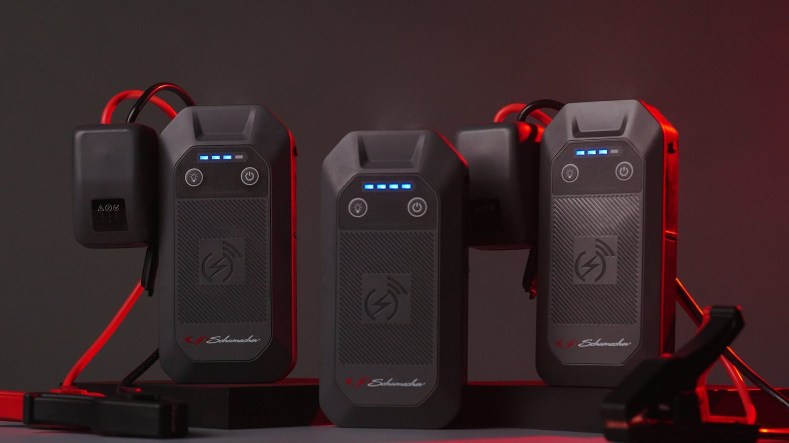 Schumacher lithium jump starters lined up on a dark set