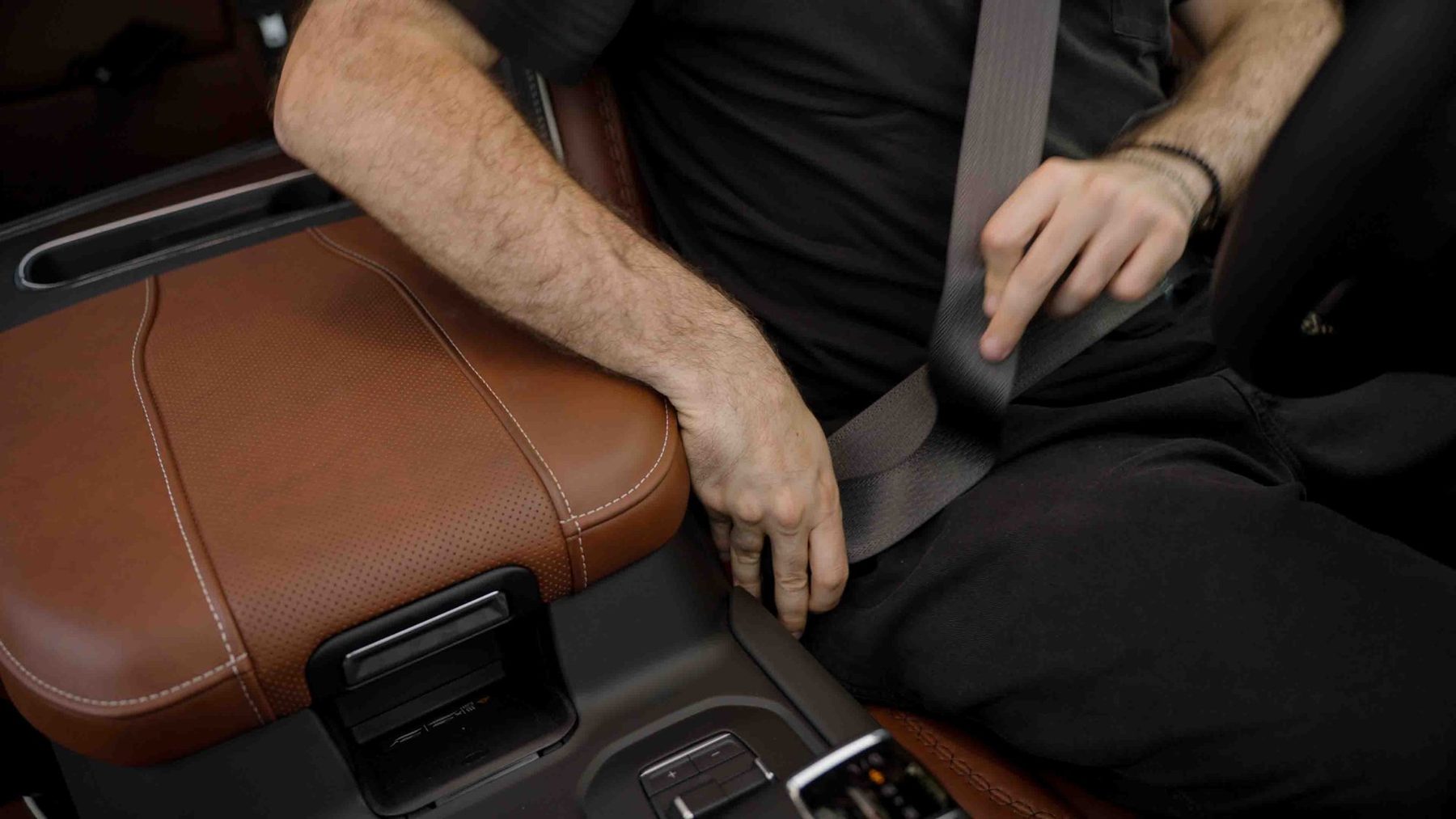 Host buckled into the leather driver seat