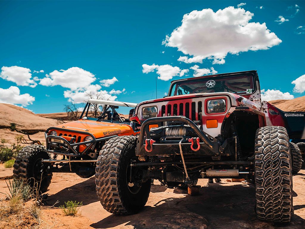 Built Jeeps lined up under a blue sky