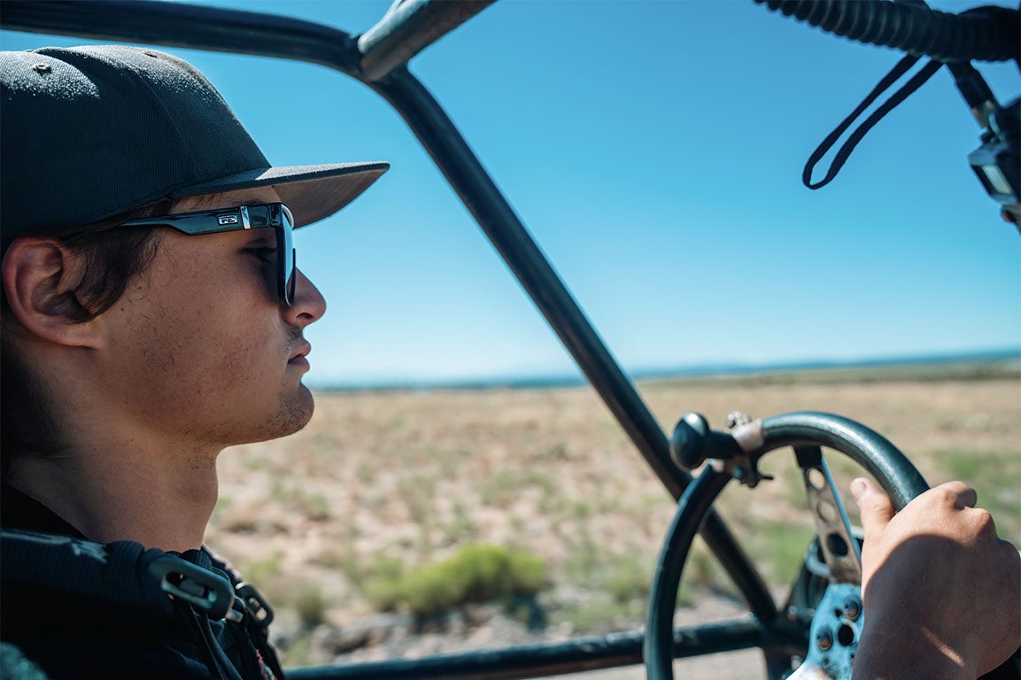 Driver in sunglasses at the wheel of a buggy