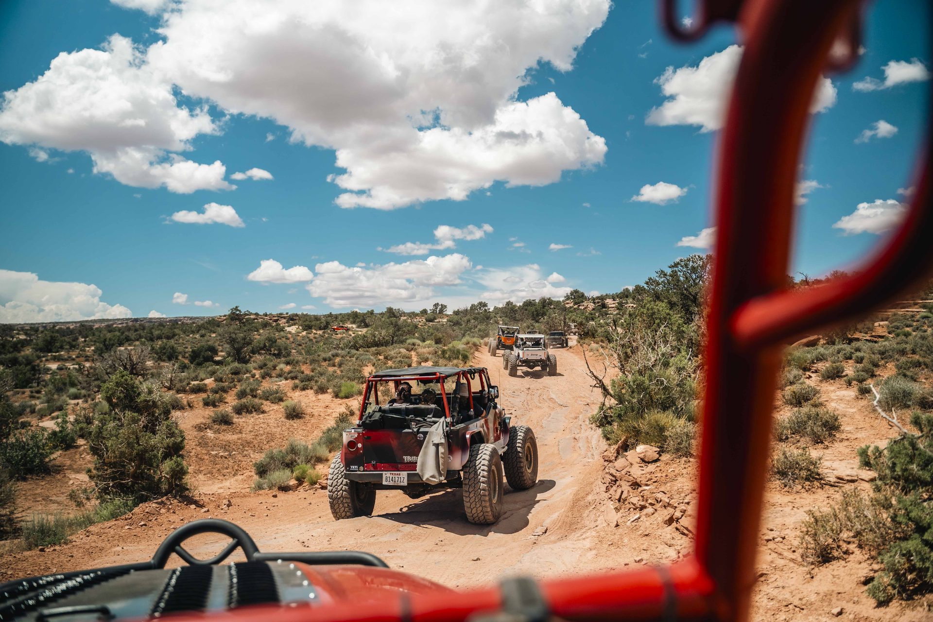 View through the roll cage of a Jeep leading the convoy