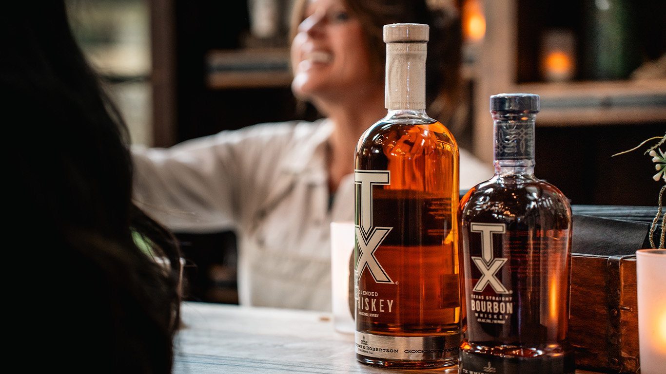 TX Whiskey and bourbon bottles on a bar