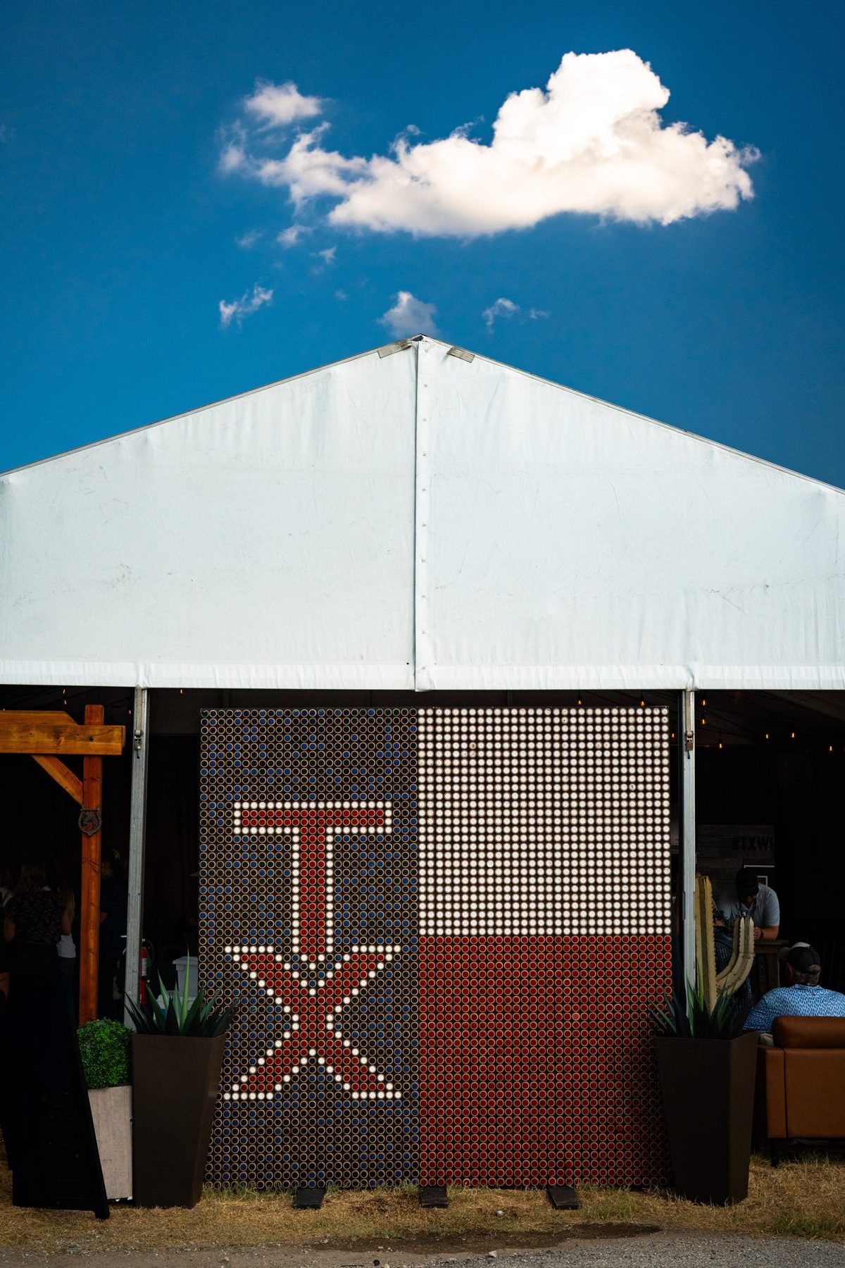 TX Whiskey logo wall at an event tent