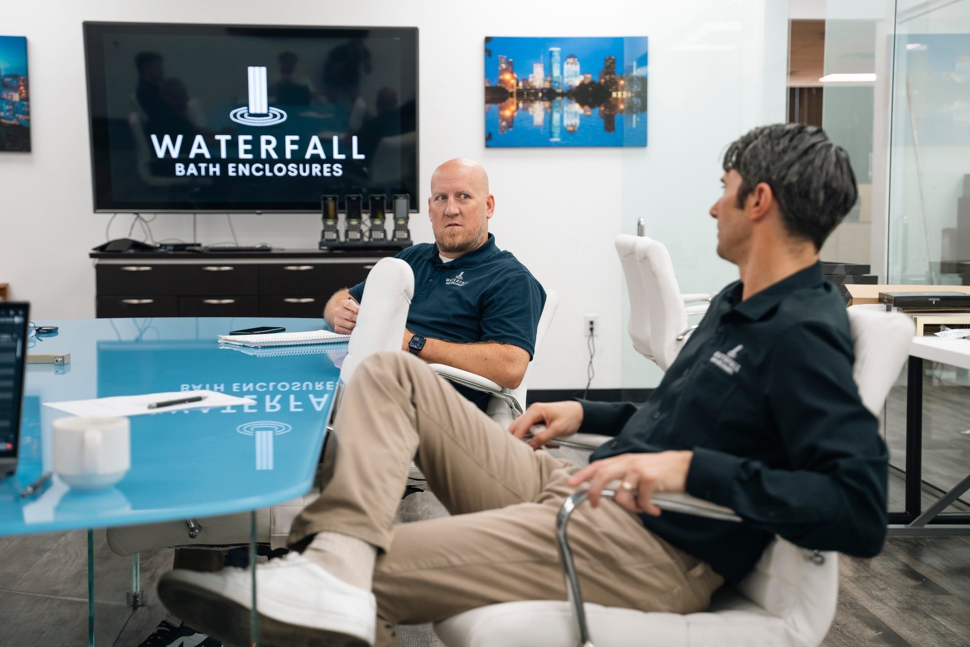 Leadership meeting in the conference room under the Waterfall logo