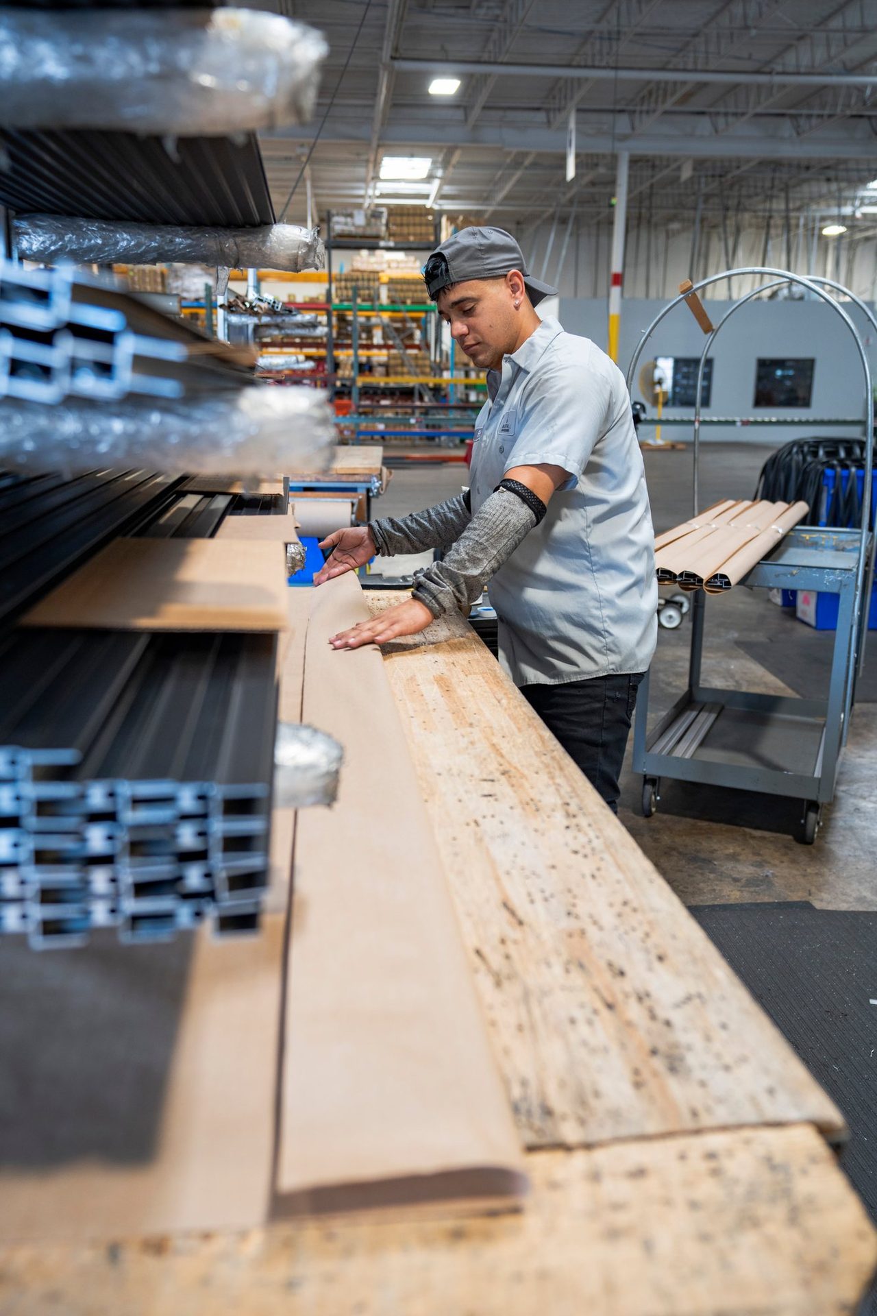 Craftsman measuring material on the shop bench